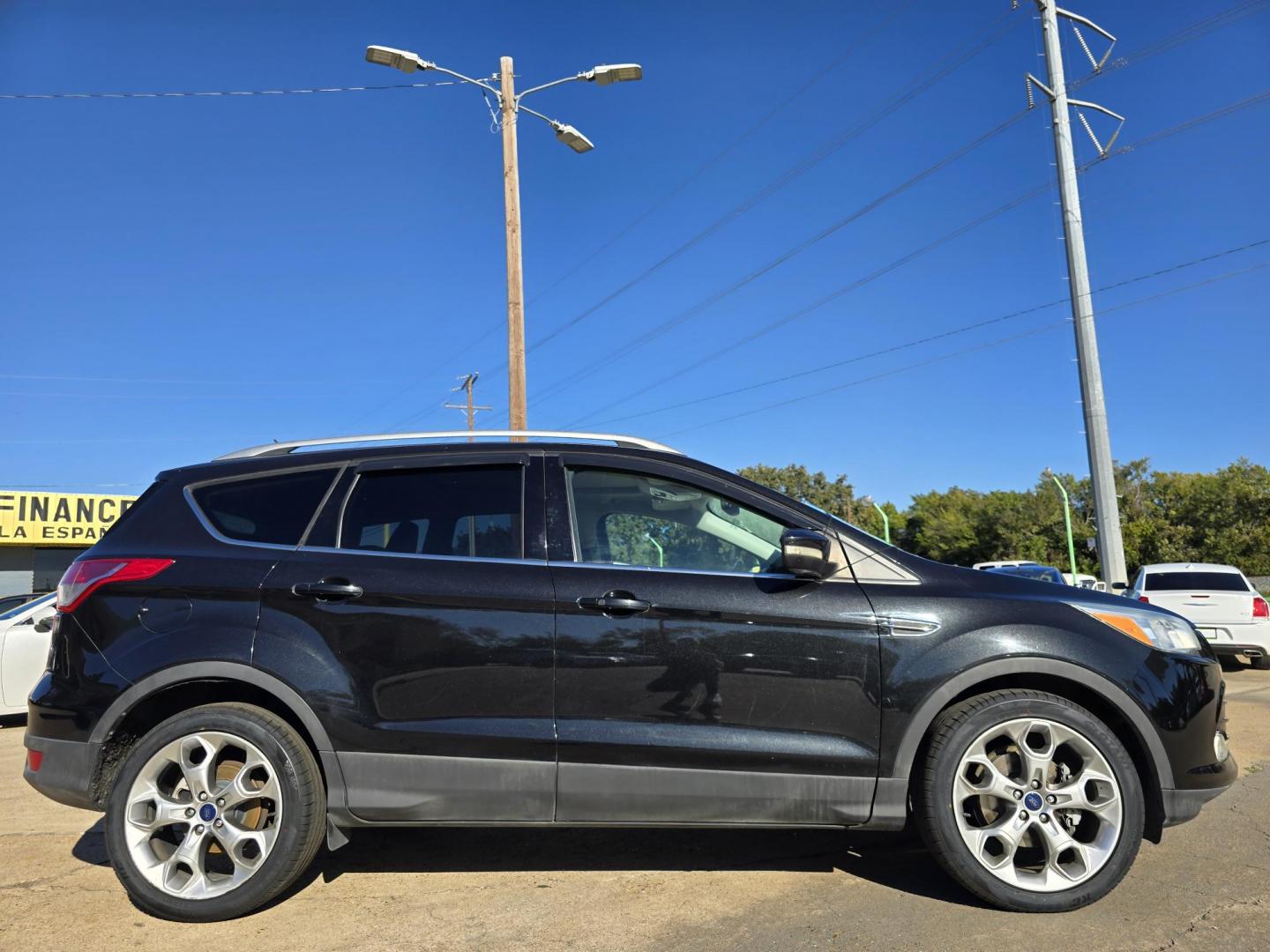 2014 BLACK Ford Escape Titanium (1FMCU0JX4EU) with an 1.6L L4 DOHC 16V engine, 6-Speed Automatic transmission, located at 2660 S.Garland Avenue, Garland, TX, 75041, (469) 298-3118, 32.885551, -96.655602 - Welcome to DallasAutos4Less, one of the Premier BUY HERE PAY HERE Dealers in the North Dallas Area. We specialize in financing to people with NO CREDIT or BAD CREDIT. We need proof of income, proof of residence, and a ID. Come buy your new car from us today!! This is a Super Clean 2014 FORD ESCAP - Photo#2