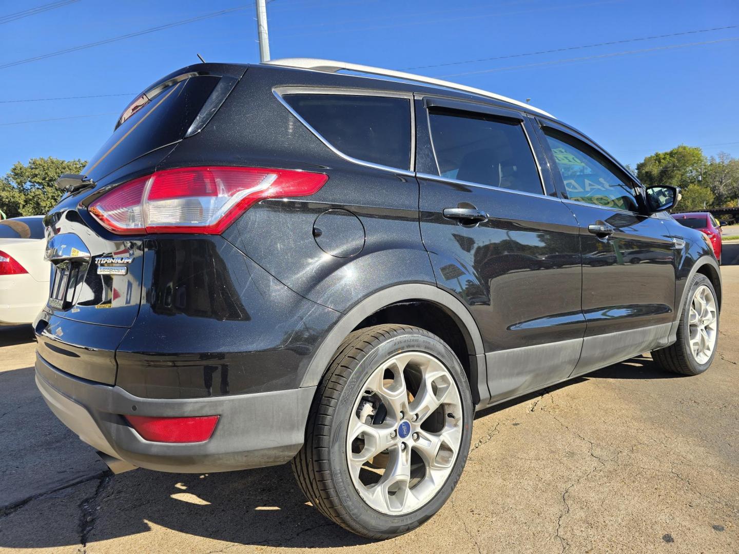 2014 BLACK Ford Escape Titanium (1FMCU0JX4EU) with an 1.6L L4 DOHC 16V engine, 6-Speed Automatic transmission, located at 2660 S.Garland Avenue, Garland, TX, 75041, (469) 298-3118, 32.885551, -96.655602 - Welcome to DallasAutos4Less, one of the Premier BUY HERE PAY HERE Dealers in the North Dallas Area. We specialize in financing to people with NO CREDIT or BAD CREDIT. We need proof of income, proof of residence, and a ID. Come buy your new car from us today!! This is a Super Clean 2014 FORD ESCAP - Photo#3