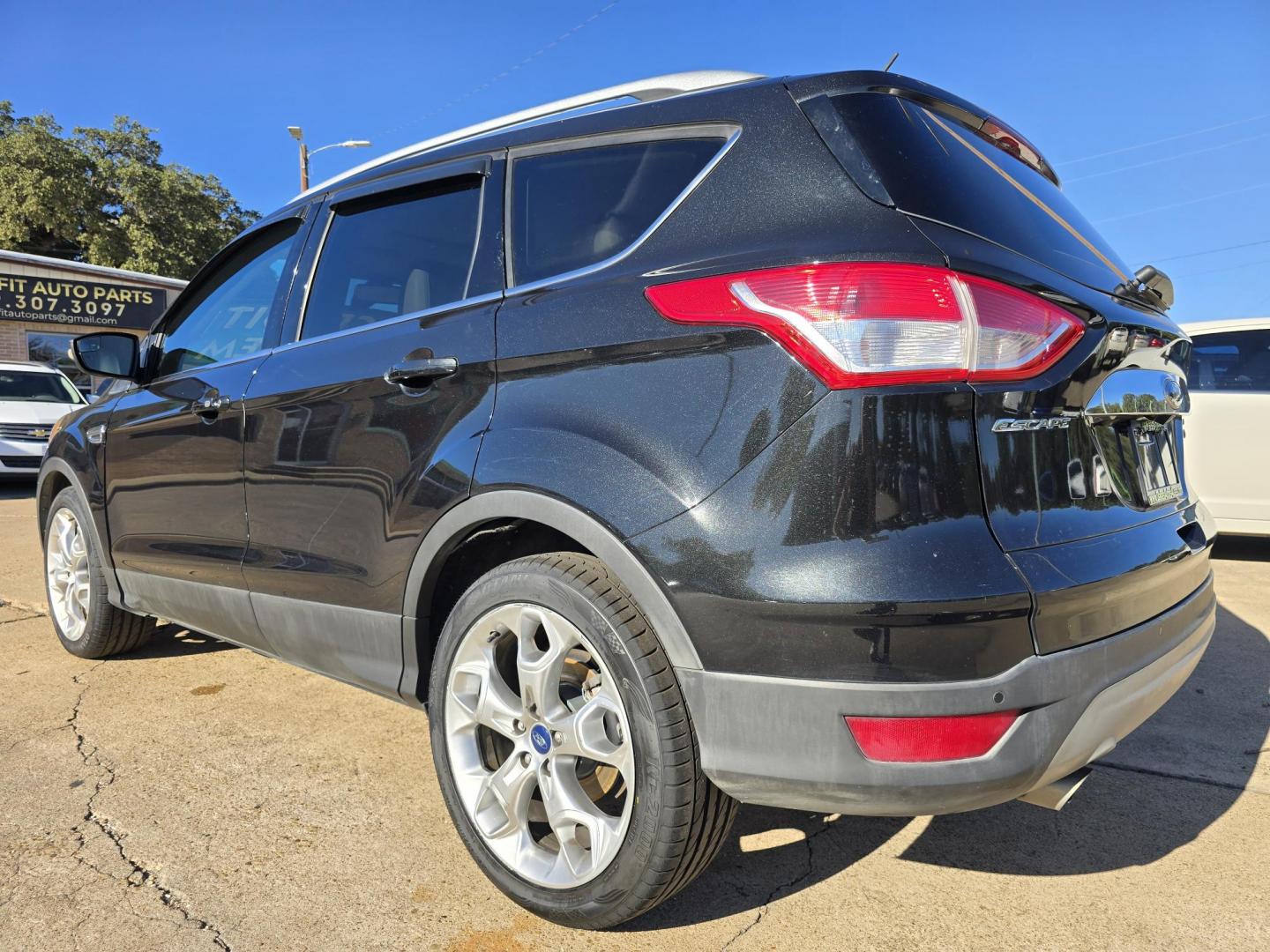 2014 BLACK Ford Escape Titanium (1FMCU0JX4EU) with an 1.6L L4 DOHC 16V engine, 6-Speed Automatic transmission, located at 2660 S.Garland Avenue, Garland, TX, 75041, (469) 298-3118, 32.885551, -96.655602 - Welcome to DallasAutos4Less, one of the Premier BUY HERE PAY HERE Dealers in the North Dallas Area. We specialize in financing to people with NO CREDIT or BAD CREDIT. We need proof of income, proof of residence, and a ID. Come buy your new car from us today!! This is a Super Clean 2014 FORD ESCAP - Photo#5